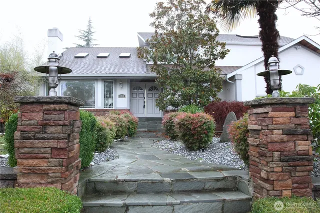 a front view of a house with a garden