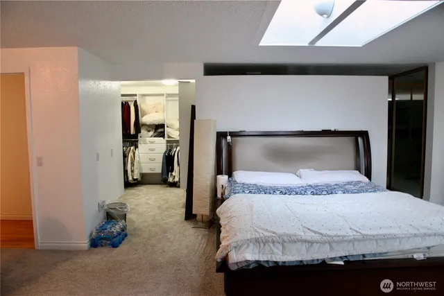 a bedroom with a bed and a walk in closet