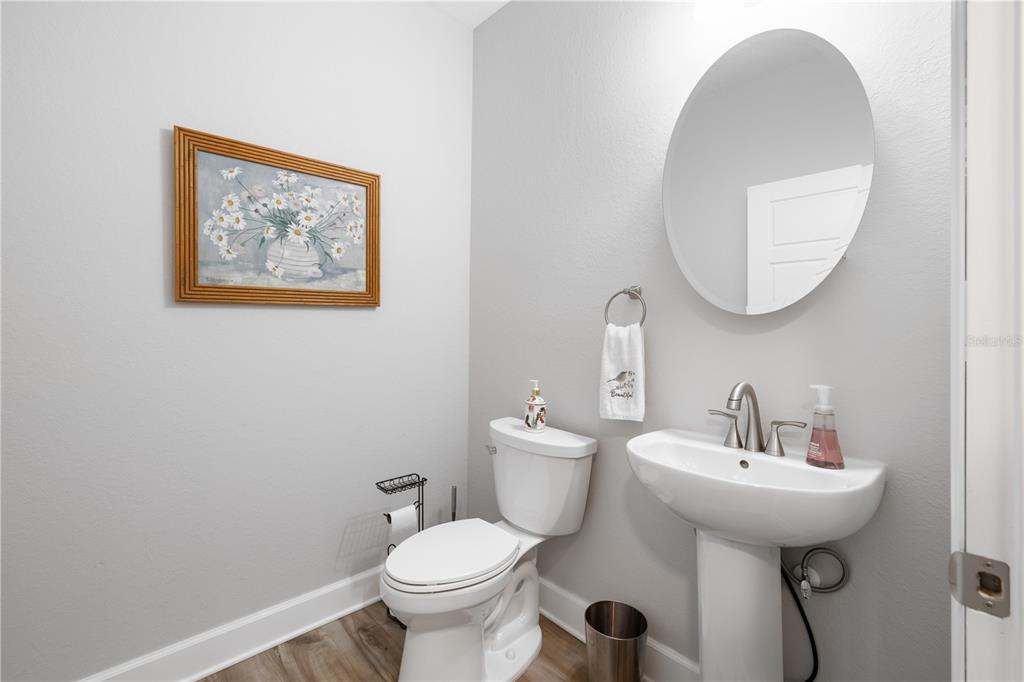 5149 Southwest 119th Road Lake Butler, FL 32054 - Photo 20 of 40 a bathroom with a toilet a sink and mirror