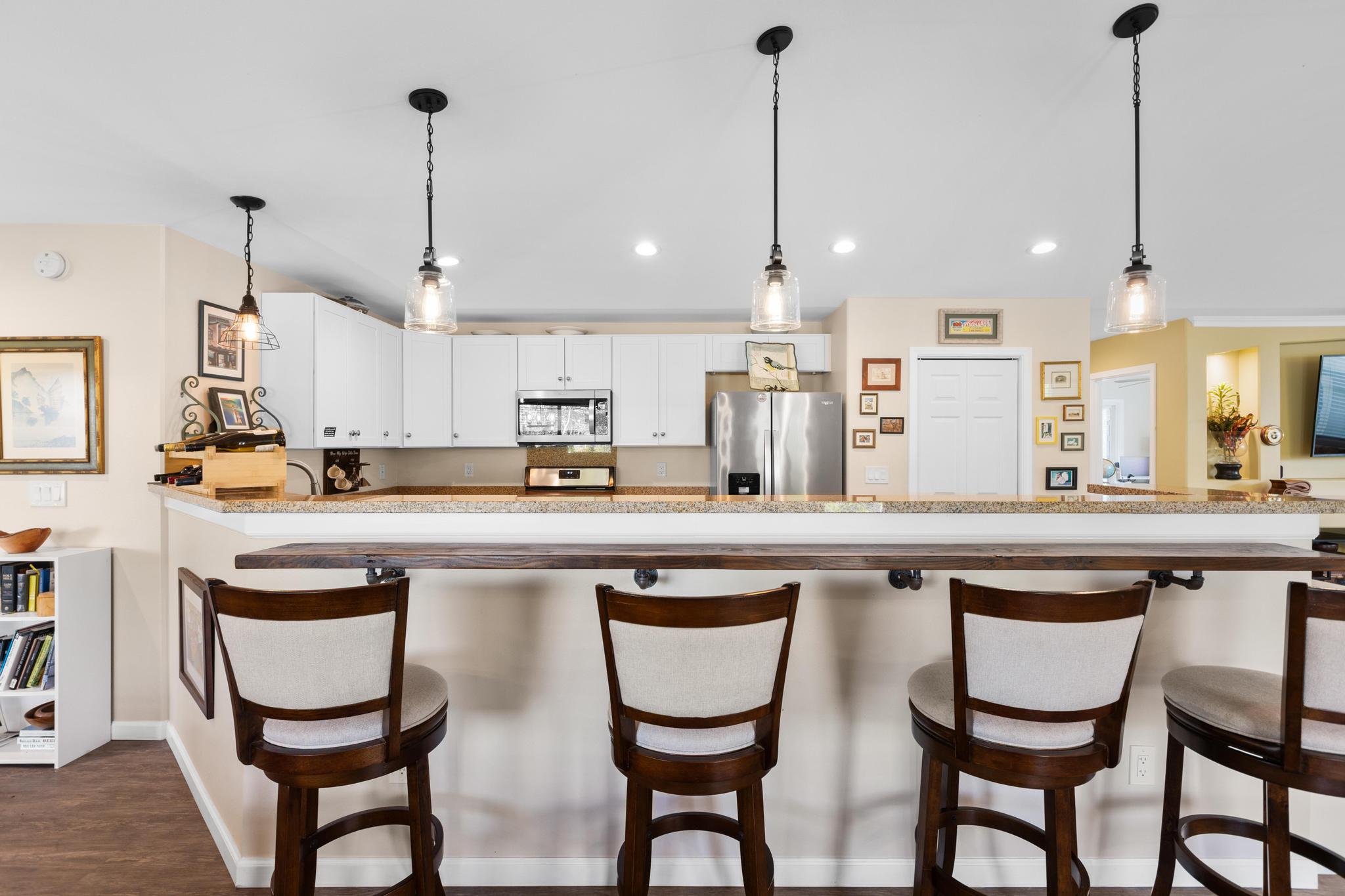 15-1635 Beach Road Keaau, HI 96749 - Photo 5 of 29 a kitchen with stainless steel appliances granite countertop a stove a sink and chairs