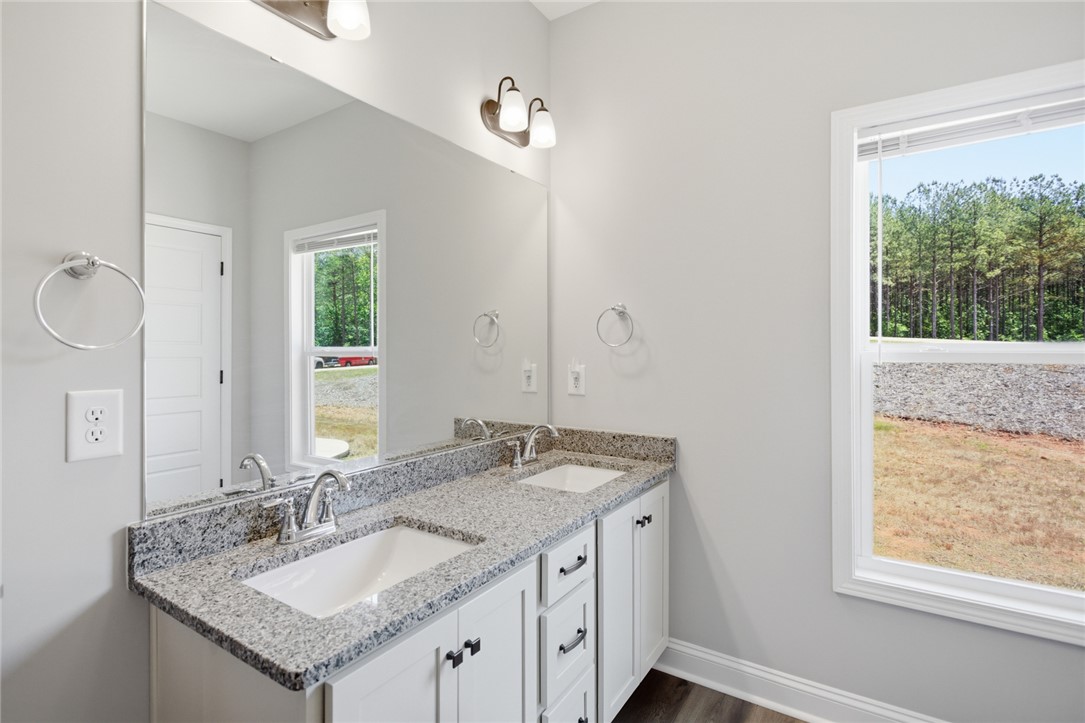 912 Watercrest Road West Union, SC 29696 - Photo 32 of 49 This bathroom features a double vanity with granite counters, offering both style and functionality.