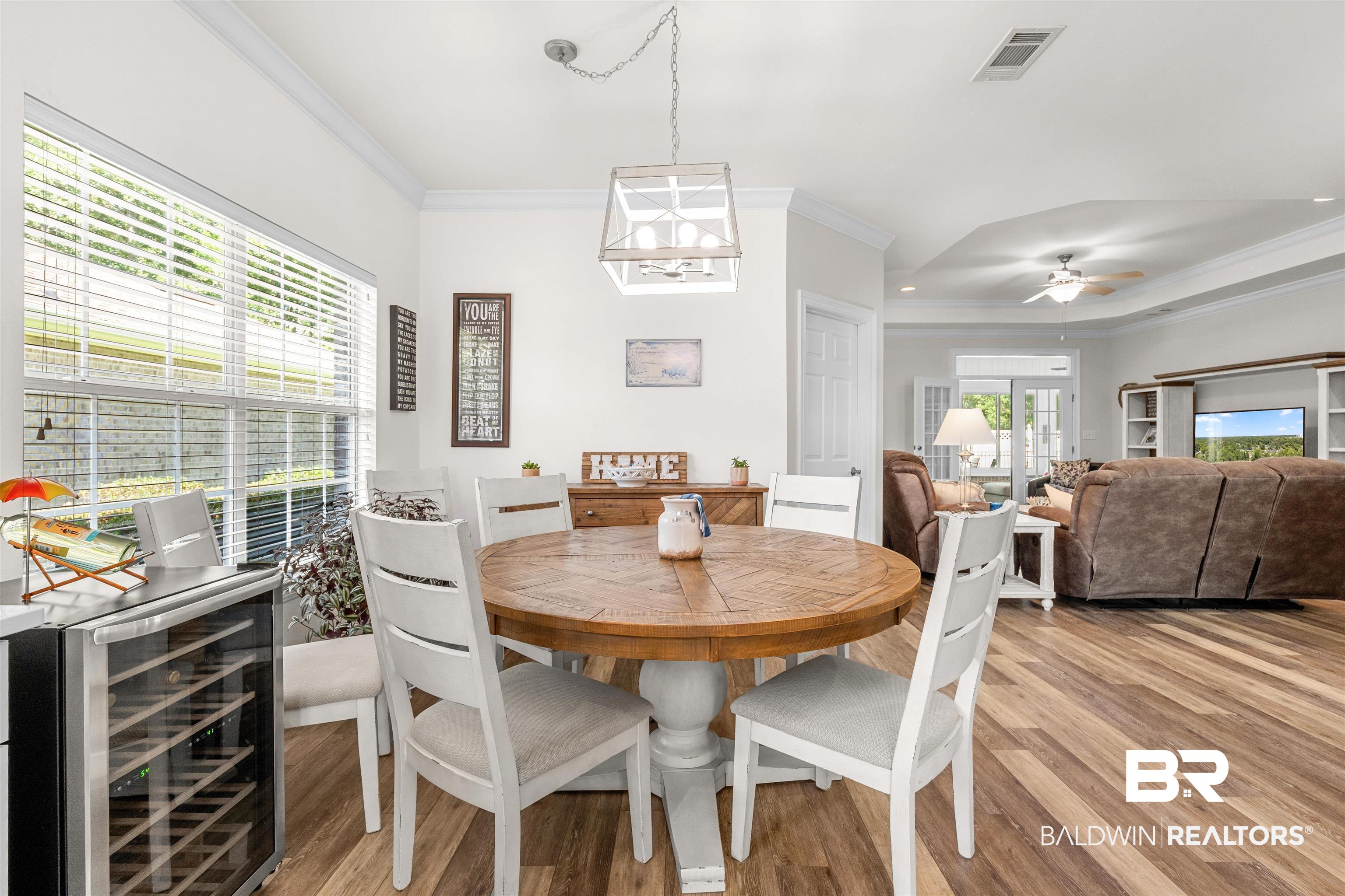 141 Mark Twain Loop Foley, AL 36535 - Photo 8 of 55 Dining space featuring crown molding, beverage cooler, light wood finished floors, and a ceiling fan