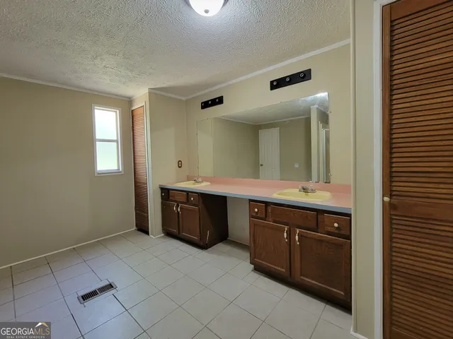 a spacious bathroom with a tub sink and a mirror