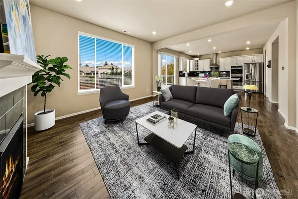 a living room with furniture and a potted plant