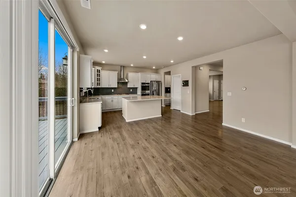a view of a kitchen with cabinets and stainless steel appliances