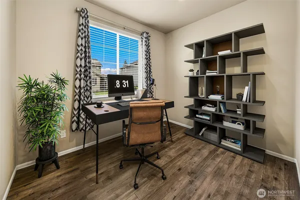 a view of a workspace with furniture and a potted plant