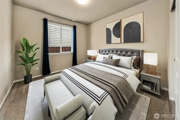 a bedroom with a bed and a potted plant