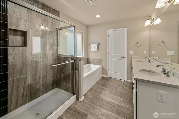 a bathroom with a double vanity sink mirror and shower