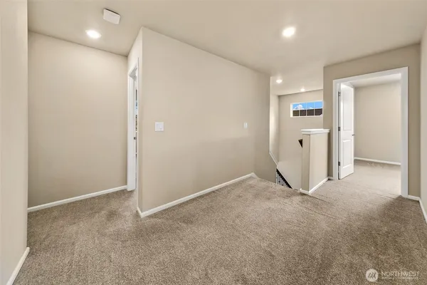 an empty room with closet and wooden floor