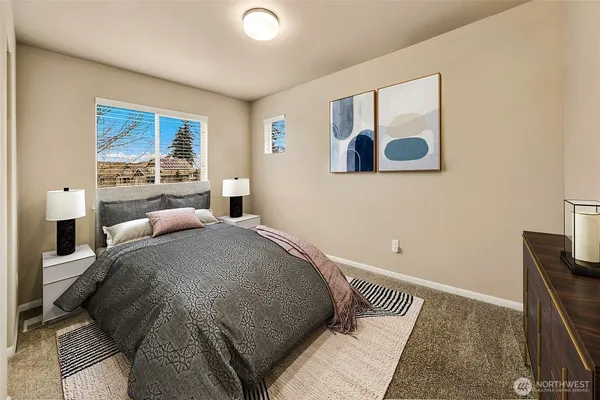 a bedroom with a bed and painting on the wall