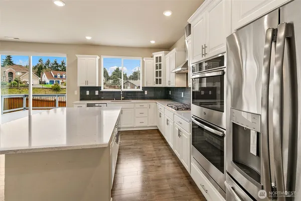 a kitchen with stainless steel appliances a refrigerator sink and stove