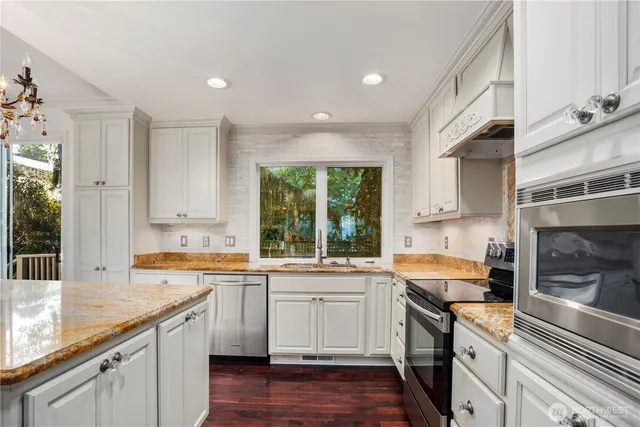 a kitchen with a sink stove and cabinets