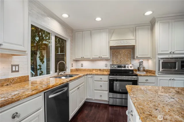 a kitchen with a sink stove top oven and cabinets