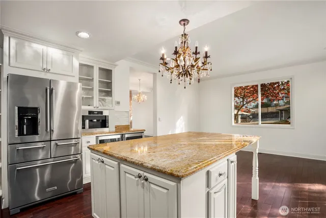 a kitchen with stainless steel appliances granite countertop a sink and stove
