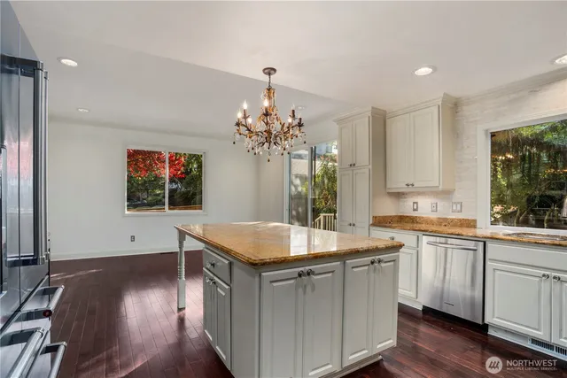 a kitchen with a sink cabinets and wooden floor