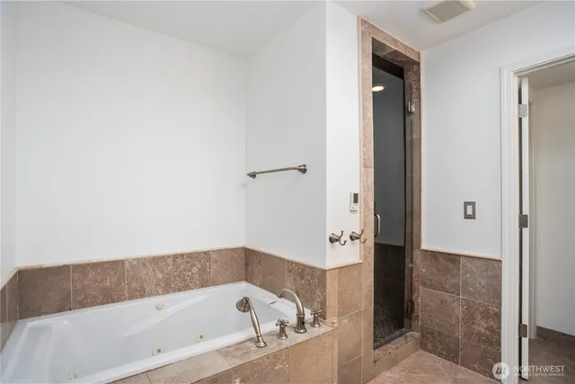 a bathroom with a bathtub and a shower