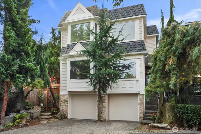a house that has a tree in front of the house