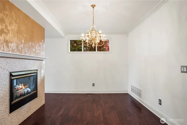 a room with fireplace and chandelier