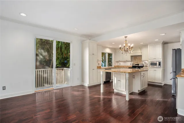 a kitchen with white cabinets and appliances