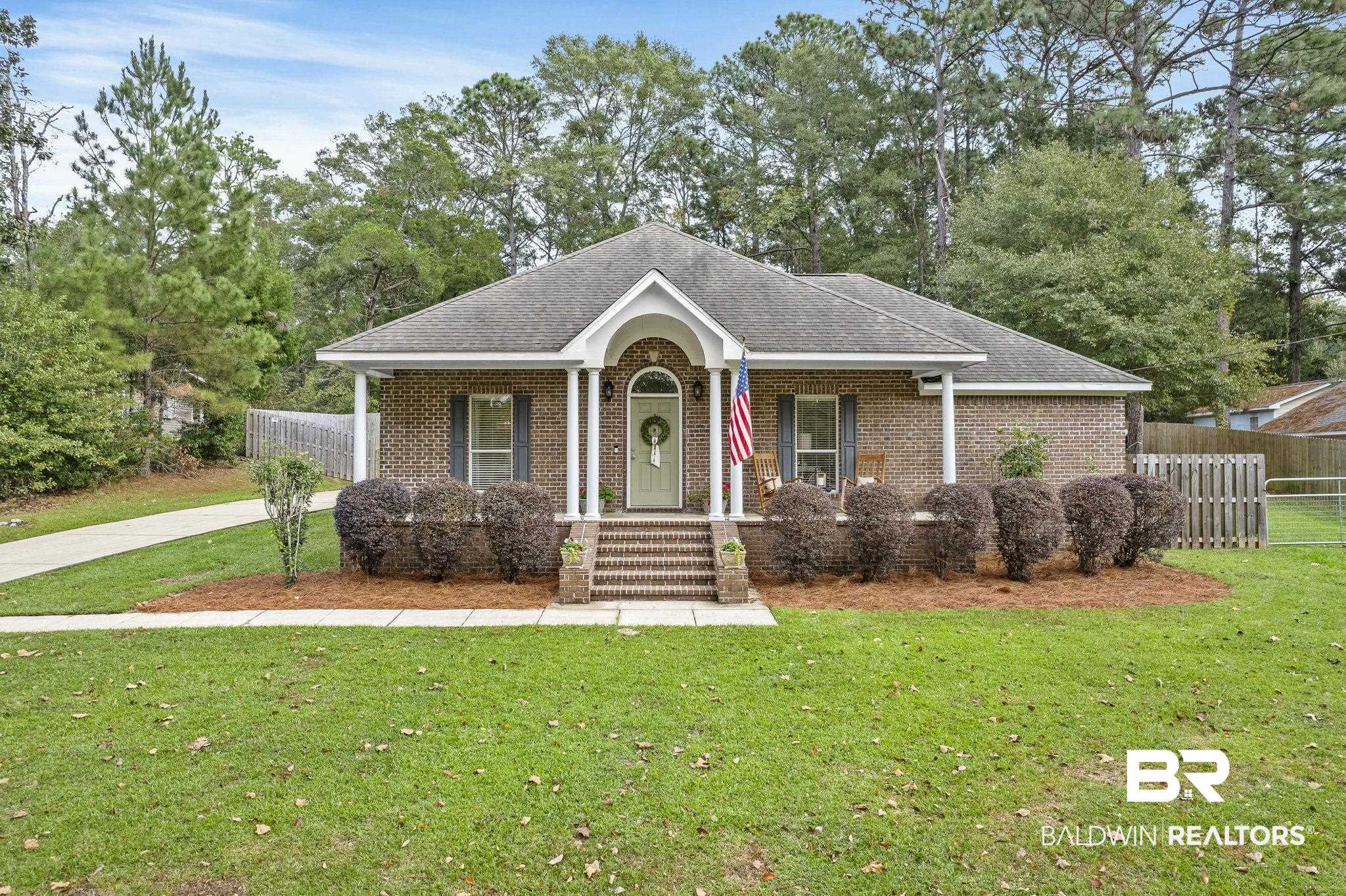 32072 Buzbee Road Daphne, AL 36527 - Photo 1 of 41 View of front of property featuring covered porch and a front yard