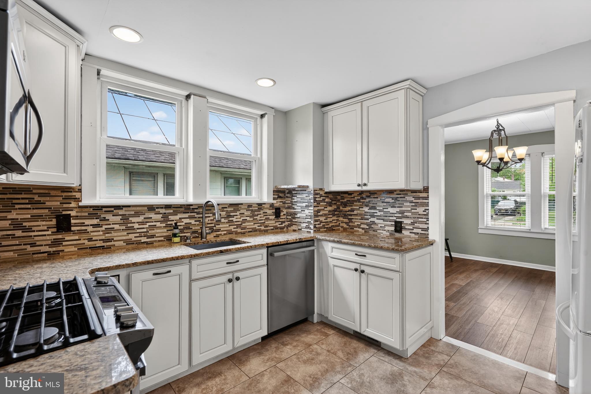 106 Ford Street Voorhees, NJ 08043 - Photo 14 of 36 a kitchen with stainless steel appliances granite countertop a stove and a sink