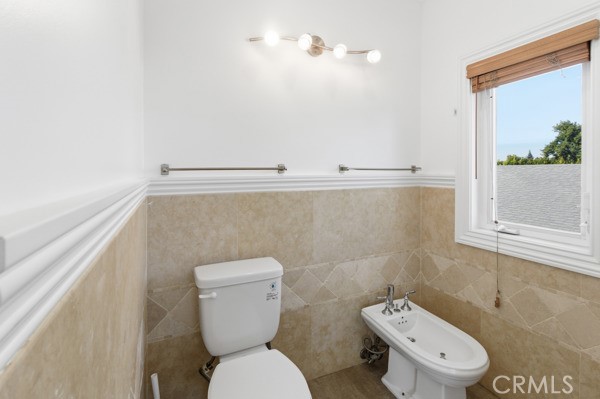 5048 Hesperia Avenue Encino, CA 91316 - Photo 13 of 30 a white toilet sitting next to a bathroom sink