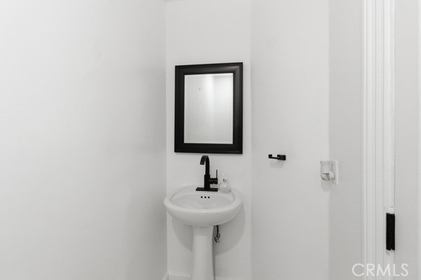 5048 Hesperia Avenue Encino, CA 91316 - Photo 17 of 30 a bathroom with a sink and mirror