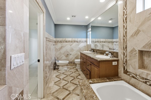 5048 Hesperia Avenue Encino, CA 91316 - Photo 19 of 30 a spacious bathroom with a double vanity sink mirror and toilet