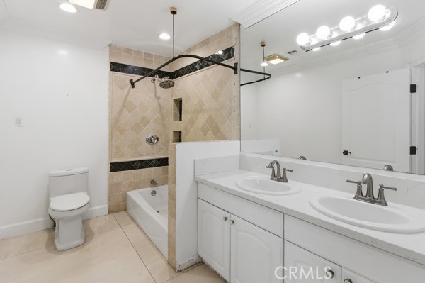 5048 Hesperia Avenue Encino, CA 91316 - Photo 23 of 30 a bathroom with a sink a toilet a mirror and shower