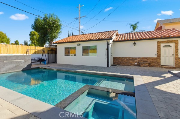 5048 Hesperia Avenue Encino, CA 91316 - Photo 28 of 30 a view of a house with a backyard pool and sitting area