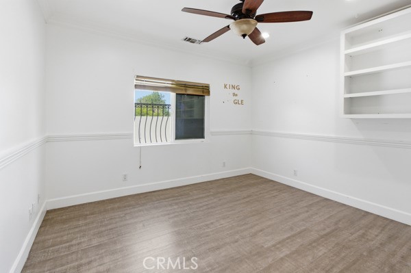 5048 Hesperia Avenue Encino, CA 91316 - Photo 7 of 30 an empty room with a window and a ceiling fan