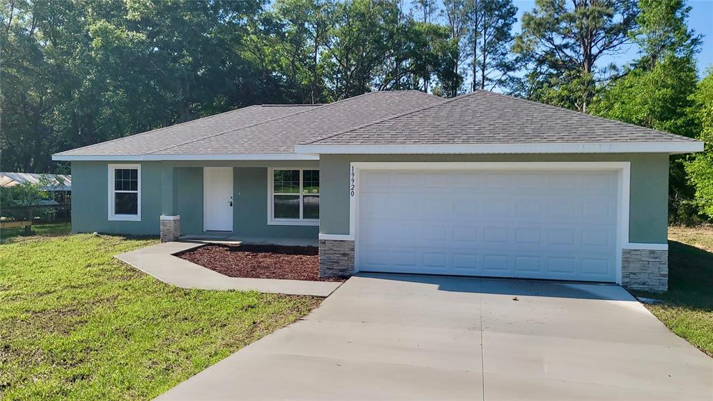 19920 Eagle Drive Dunnellon, FL 34431 - Photo 1 of 1 a front view of a house with garden