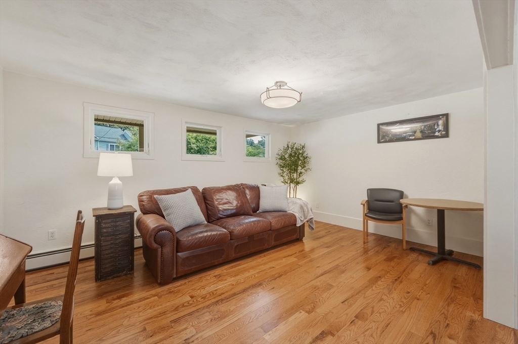 90 Rounsevell Road Tewksbury, MA 01876 - Photo 9 of 42 a living room with furniture and a wooden floor