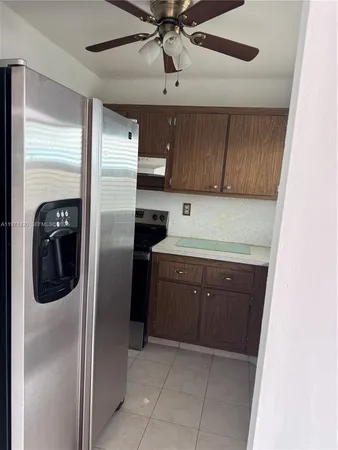 a kitchen with a refrigerator and a sink