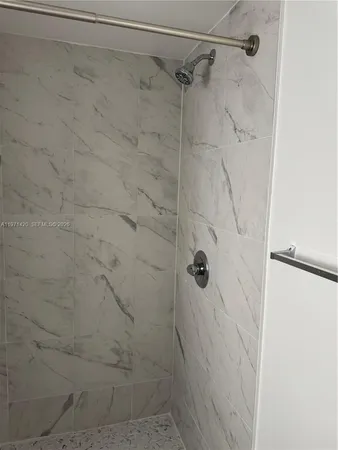 a bathroom with a toilet and a shower curtain