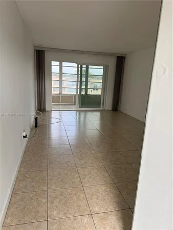 a view of an empty room with glass door