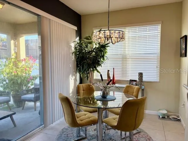 a dining room with furniture and a potted plants