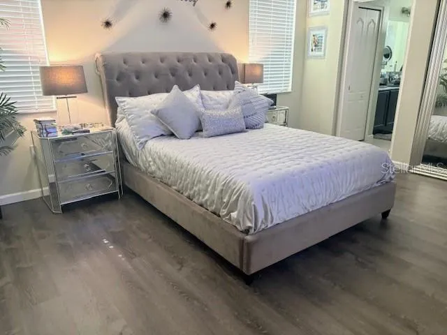 a large bed sitting in a bedroom next to a window