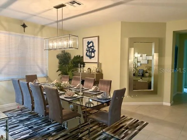 a dining room with furniture a chandelier and wooden floor