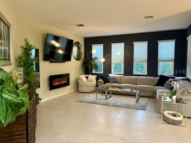 a living room with furniture and a fireplace