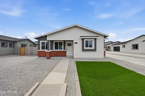 a large kitchen with cabinets a sink and stainless steel appliances