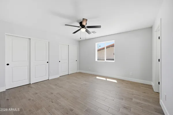 a view of a room with wooden floor and windows