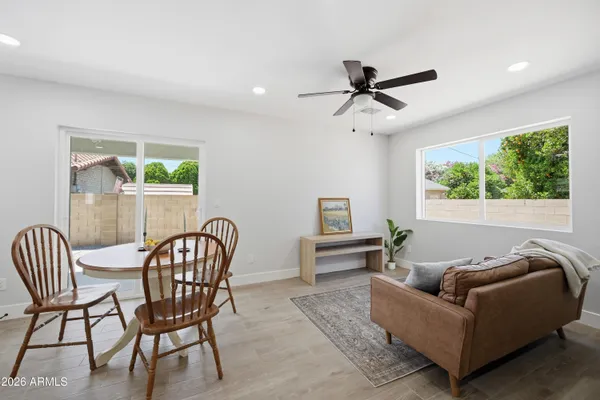 an empty room with a window and a fan