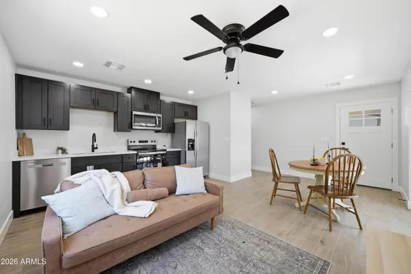 an empty room with a ceiling fan and shower