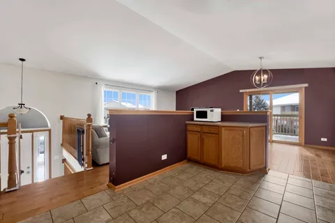 a kitchen with refrigerator and microwave