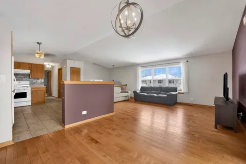 a view of kitchen with furniture and wooden floor