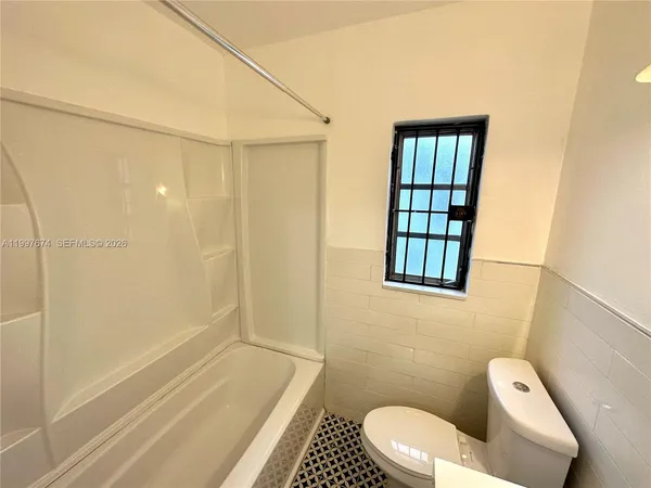 a bathroom with a toilet and shower