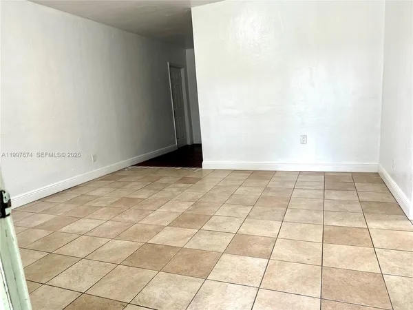 a view of empty room with white walls