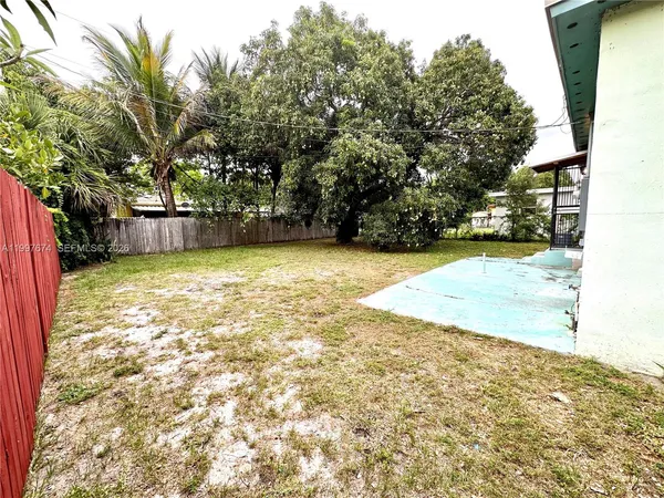 a view of yard with swimming pool and seating space