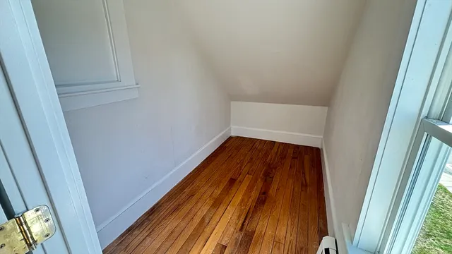 a view of walk in closet with wooden floor